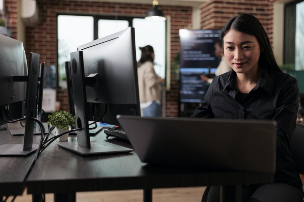 Confident cyber security officer accesing administrator rights by bypassing firewall defence system.